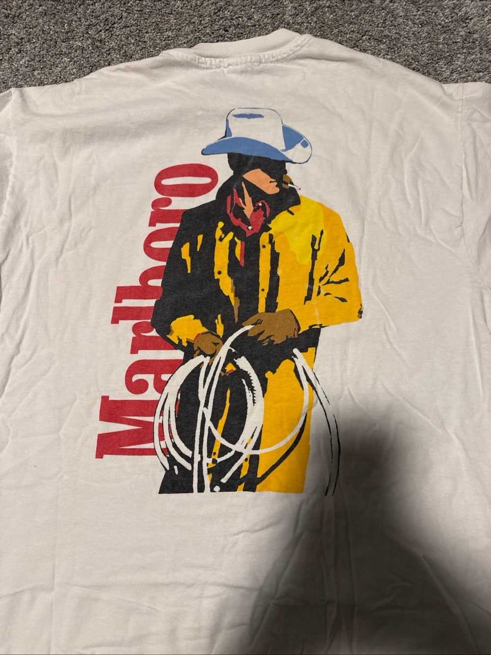 Vintage Marlboro White Graphic Cowboy Tee with Yellow and Red Print XL